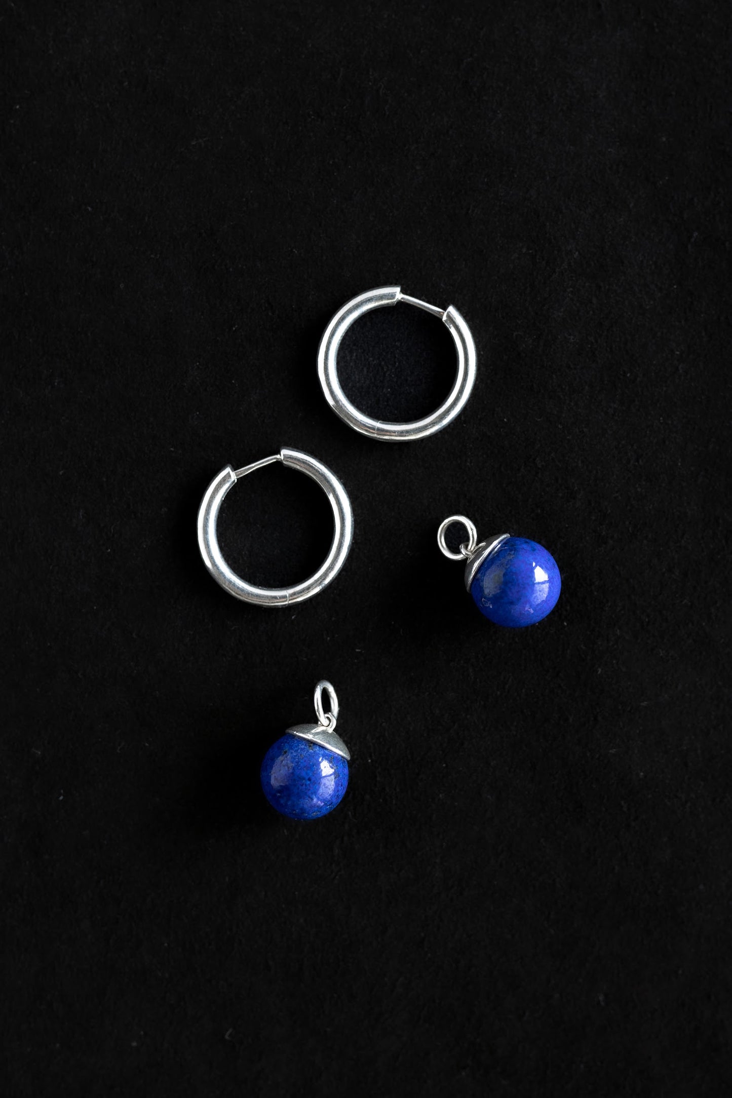 Sterling silver hoop earrings with hinge closure and 12mm blue lapis stone charms that can be removed and changed.