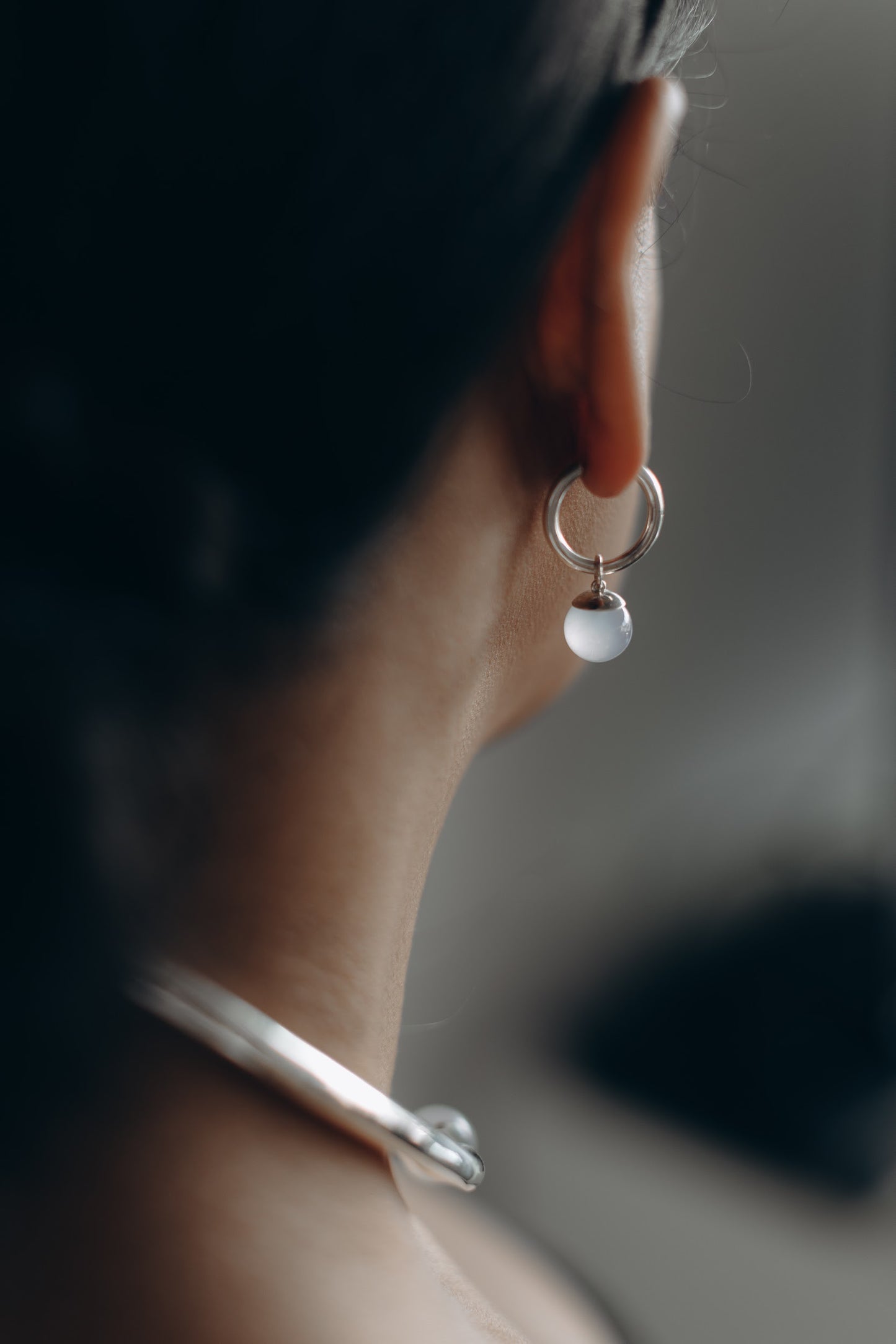 Sterling silver hoop earrings with hinge closure and 12mm light blur chalcedony stone charms that can be removed and changed.