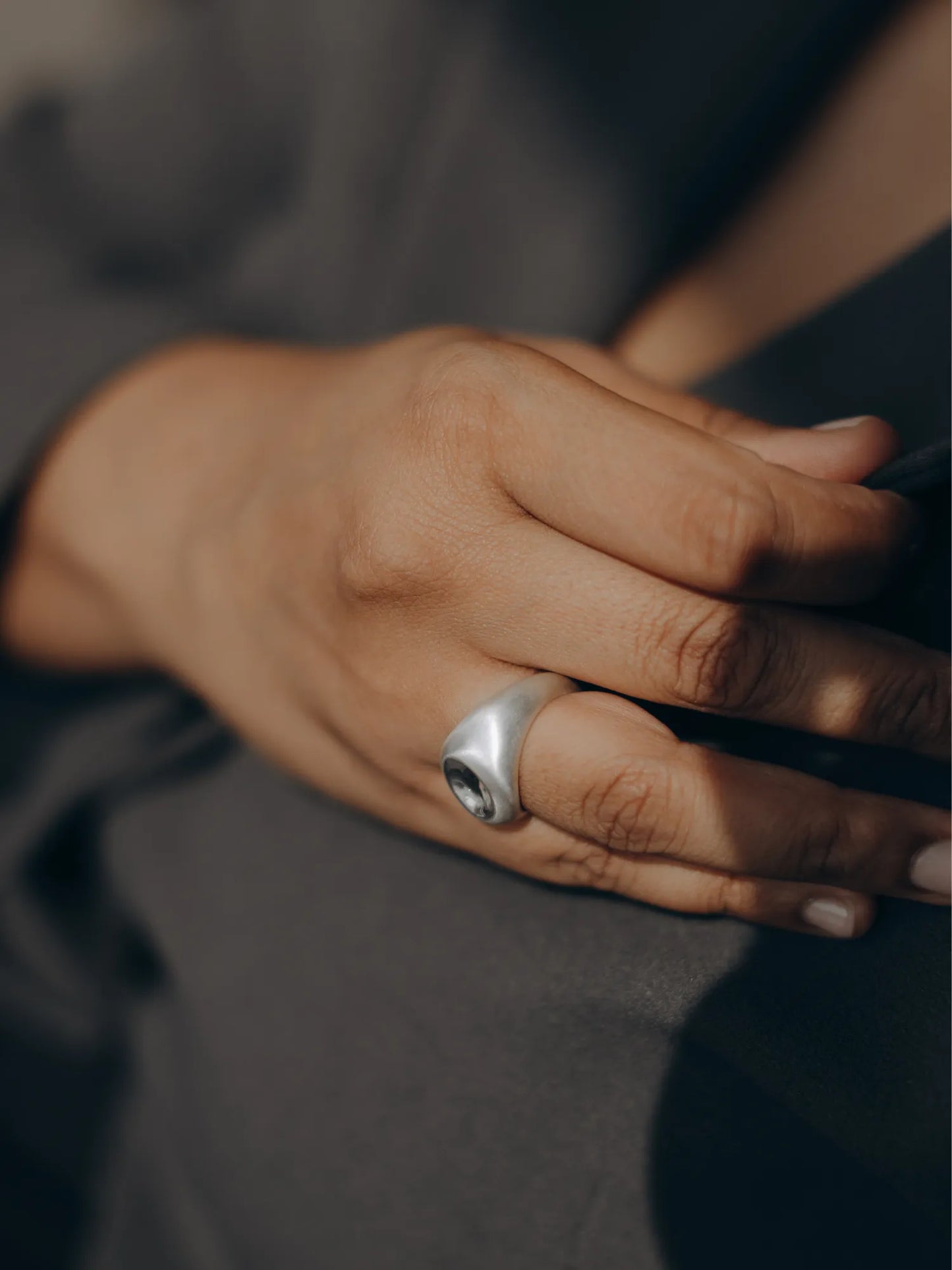 Model wearing Maancy contemporary silver ring with mirror dome design, lifestyle image showing the ergonomic fit and modern aesthetic.