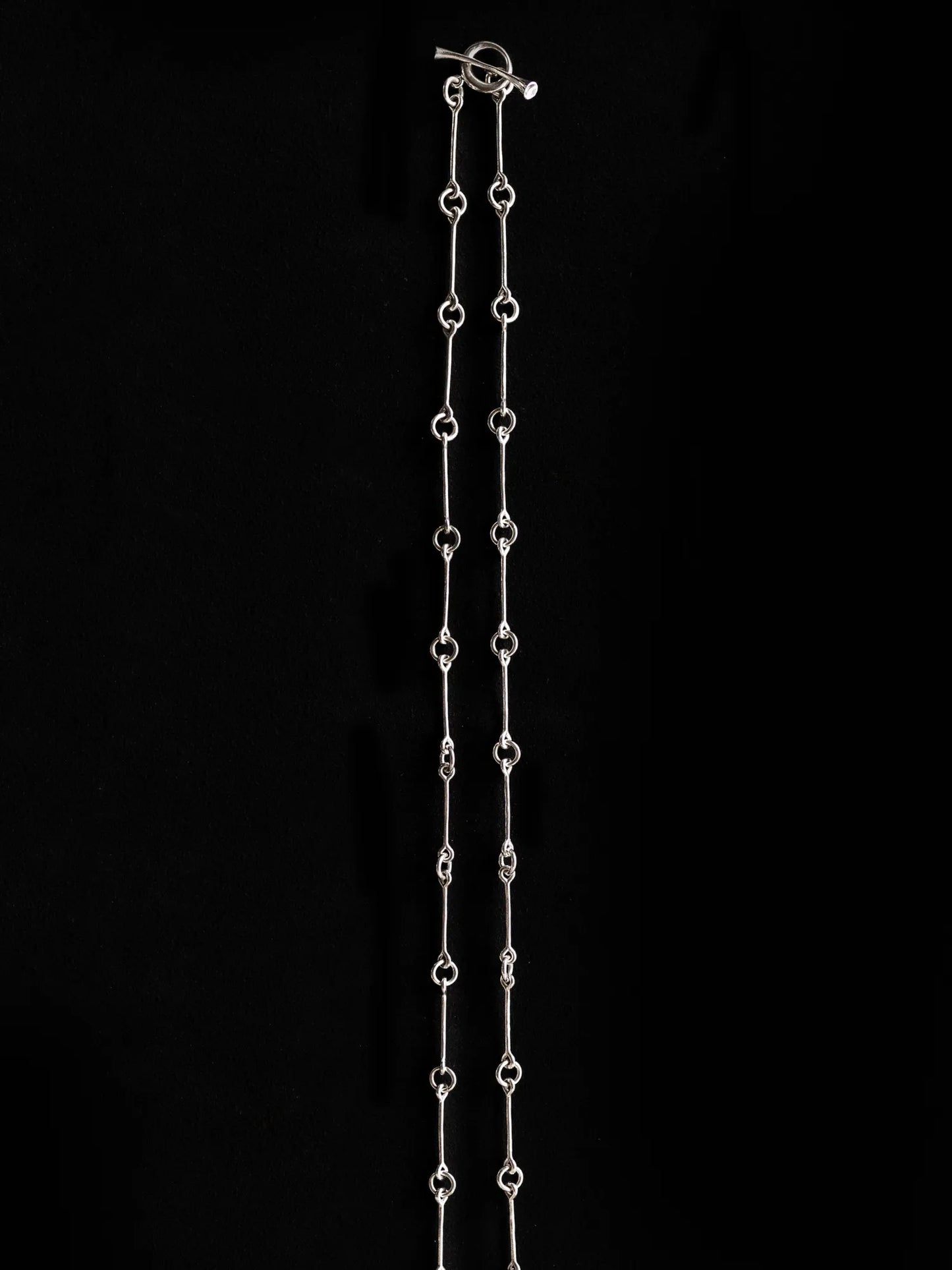 Maancy handcrafted sterling silver chain necklace with toggle clasp, featuring artisan-made connecting links in full-length display.