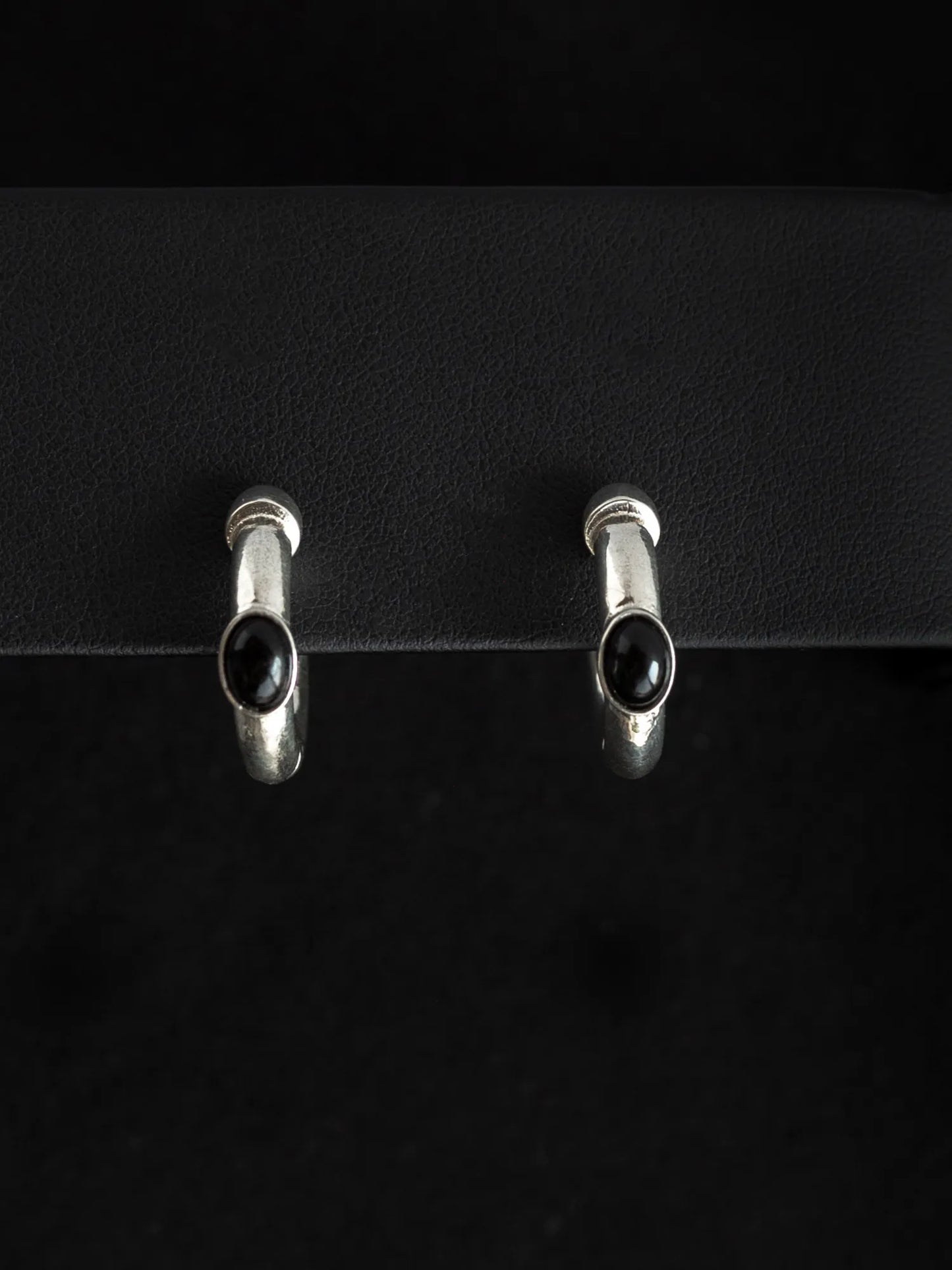 Maancy sterling silver interchangeable hoop earrings with oval onyx gemstones on black background, showcasing convertible design.