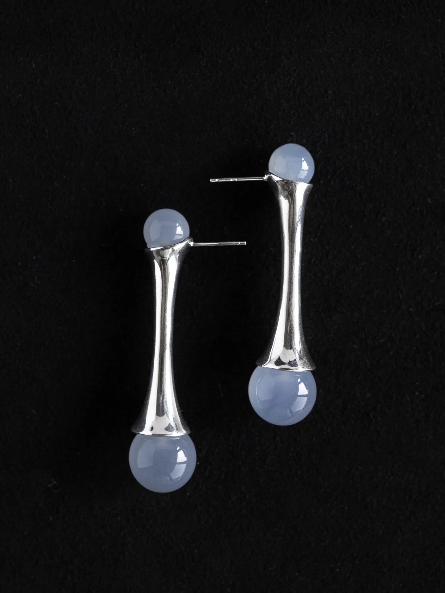 Maancy interchangeable sterling silver earrings with chalcedony stones displayed at an angle showing the modernist fluted design.