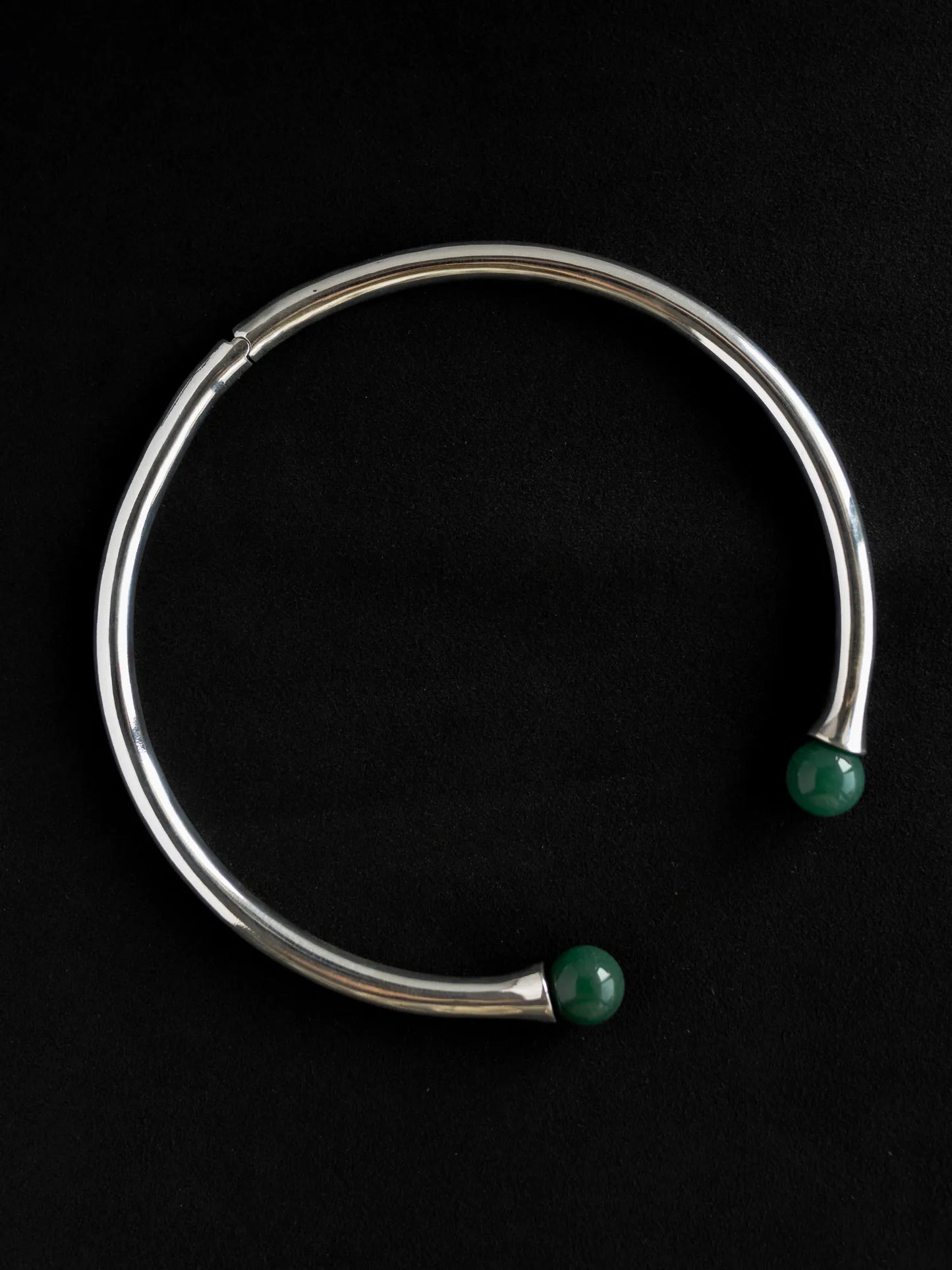 Maancy modular gemstone collar necklace in polished sterling silver with vibrant jade spheres on black background, highlighting contemporary design.