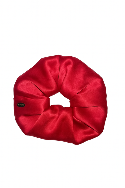 Red silk scrunchie on a white background