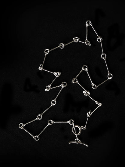 Maancy silver chain necklace artisan-made in Los Angeles studio, arranged to showcase the flowing infinity link pattern.