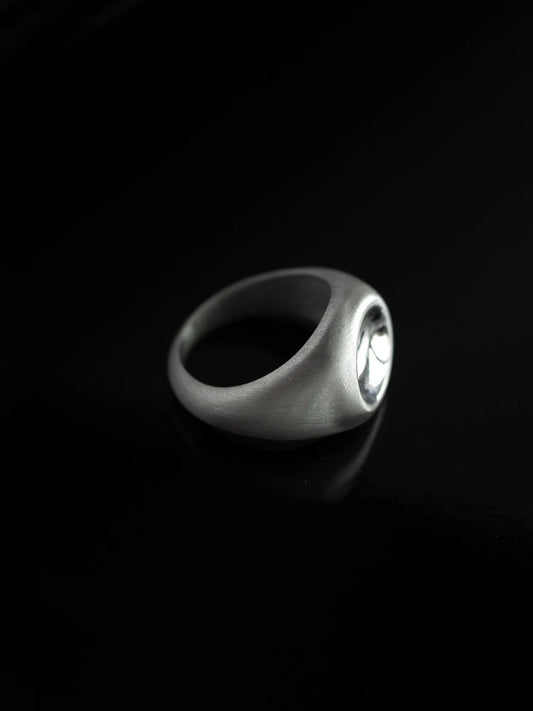 Maancy handcrafted silver dome ring with mirror-polished center against black background, showing the contrast between satin band and reflective dome.