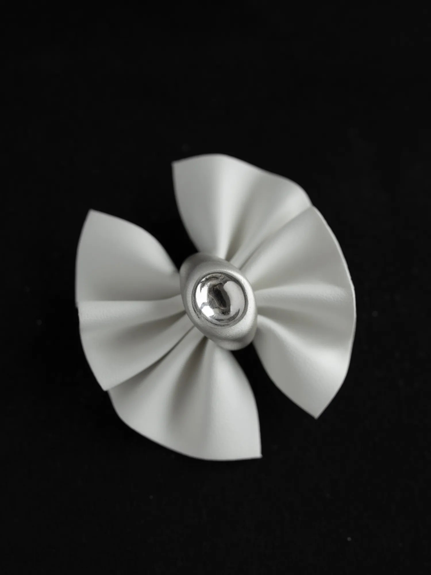 Maancy mirror dome ring in sterling silver with sculptural pleated design and polished reflective center, front view against black background.
