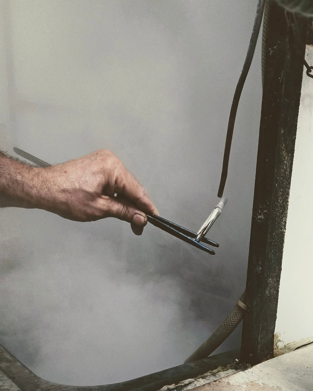 Maancy artisan hand-polishing a sculptural sterling silver bangle, demonstrating the traditional craftsmanship behind each handmade piece.